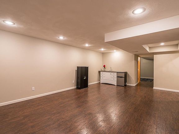 Finished basement with wet bar and refrigerator 