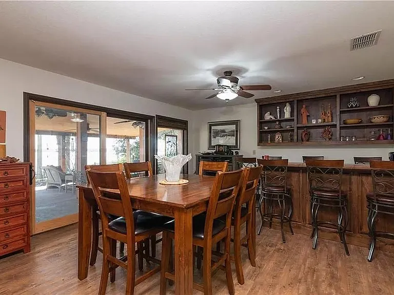 Bar / sitting area opens to walk-out covered back patio and pathway to the dock, boathouse, and lake.