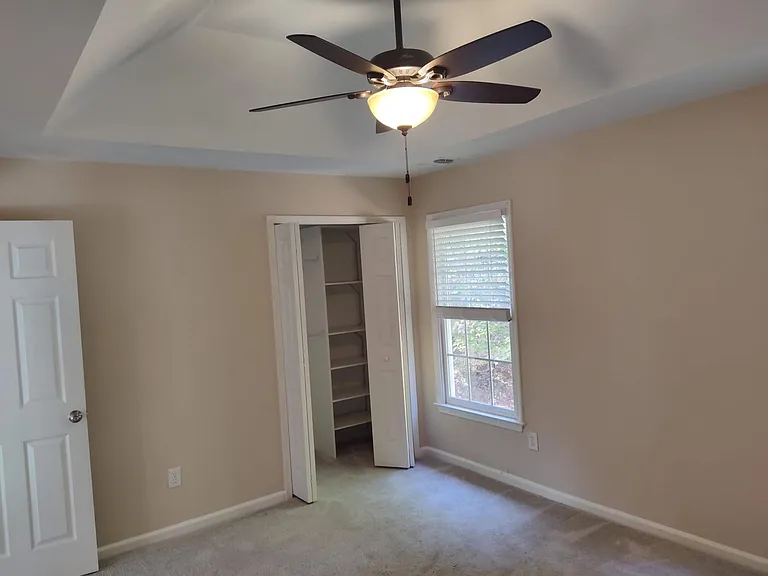 Guest bedroom has also a vaulted ceiling + an organized closet.