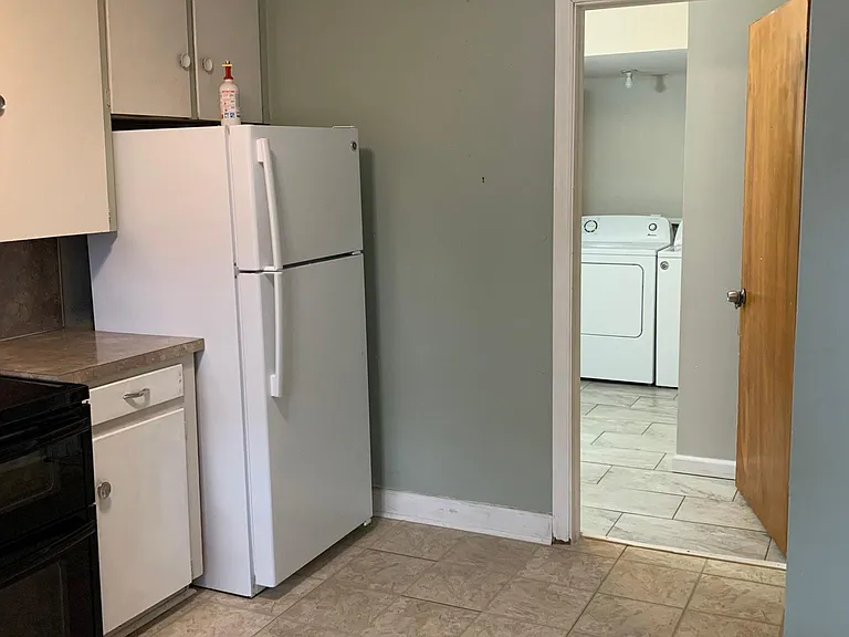 From the kitchen, leading into the half bath/laundry room