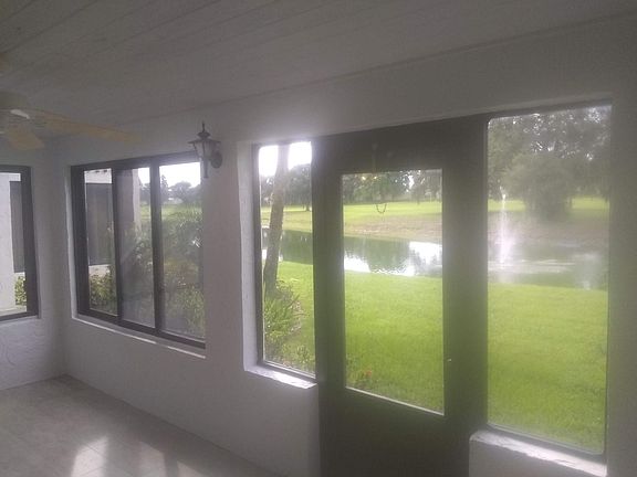 Sunroom with view of fountain and landscaping