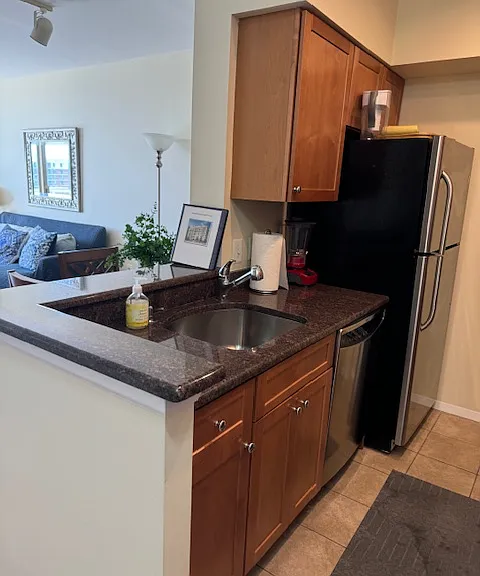 Open kitchen with granite countertops and plenty of cabinet space.