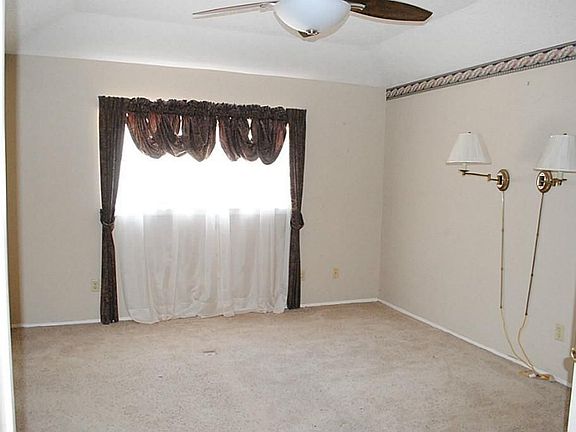 Master bedroom with master bath has updated ceiling fan on a remote.  Bathroom is tiled & updated with silestone.  Closet has a built-in safe for your valuables!