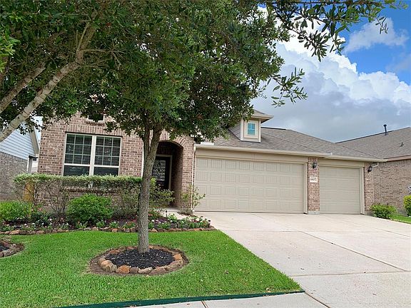 Beautiful trees and landscaping with a rock border captivate the front exterior.