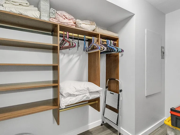 HUGE primary walk-in closet with California style shelving