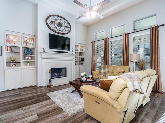 A spacious family room complete with large windows w/transoms to let the natural light enter the space, and a gas log fireplace to warm the hearts of all that gather here!