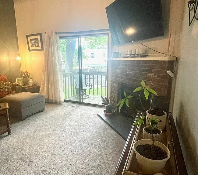 Alternative View: Sunken living room with fireplace and sliding glass doors leading to a private deck.