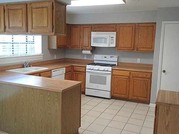 Spacious kitchen, laminate countertops, plenty of cabinet space.  Opens to breakfast area.  Light and bright.