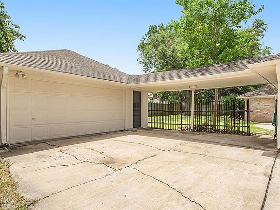 2 Car Garage with driveway shot with backyard view.