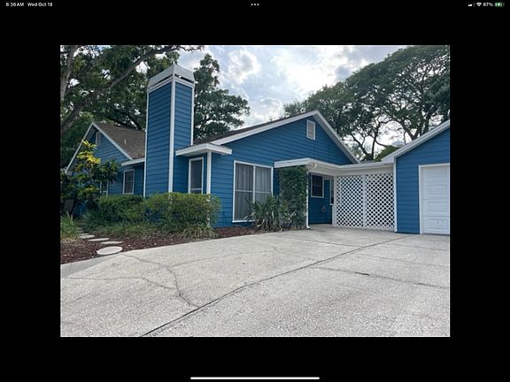 Home with detached garage with breezeway.