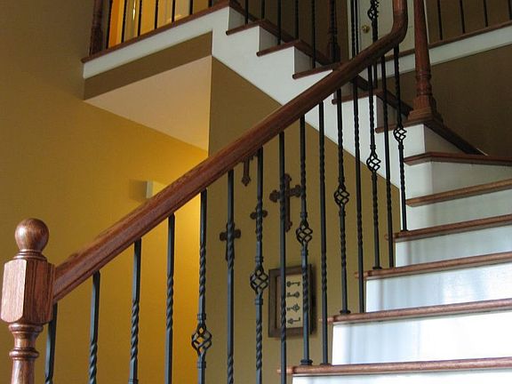Beautiful Iron and wood stairs with soaring foyer ceiling