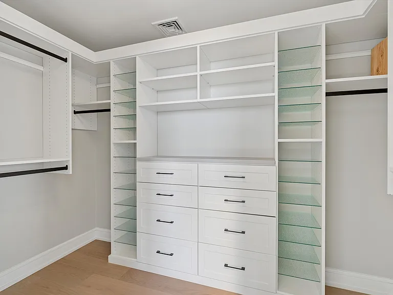Primary bedroom walk-in closet