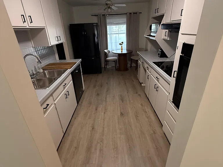 Kitchen with connection to dining room, recreation room, and garage/back door.