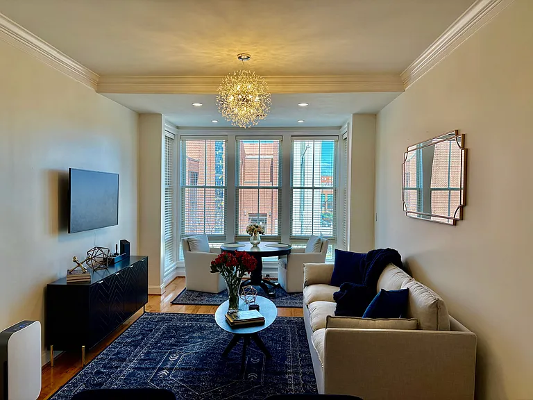 Spacious Living Room looking into the Dining Area w/ Floor to Ceiling Windows.