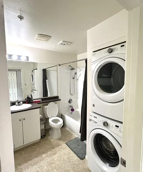 Full bathroom with washer and dryer