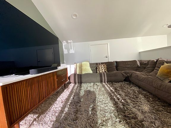 Media Room with 65 inch Smart TV. Ligne Roset Togo Original Sofa. Can also be converted to a 3rd bedroom.