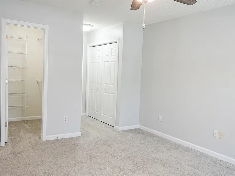 Primary suite features her and his closets
