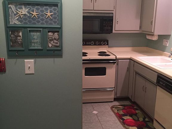 Kitchen includes stove, dishwasher, refrigerator, coffee and espresso maker, cooking and eating items.