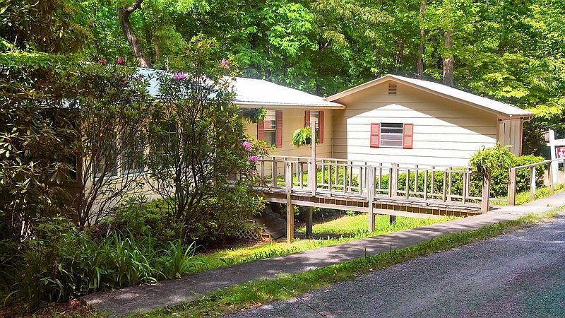 Your cottage nestled in the rhododendron : Far right is garage, level access via the bridge to the G