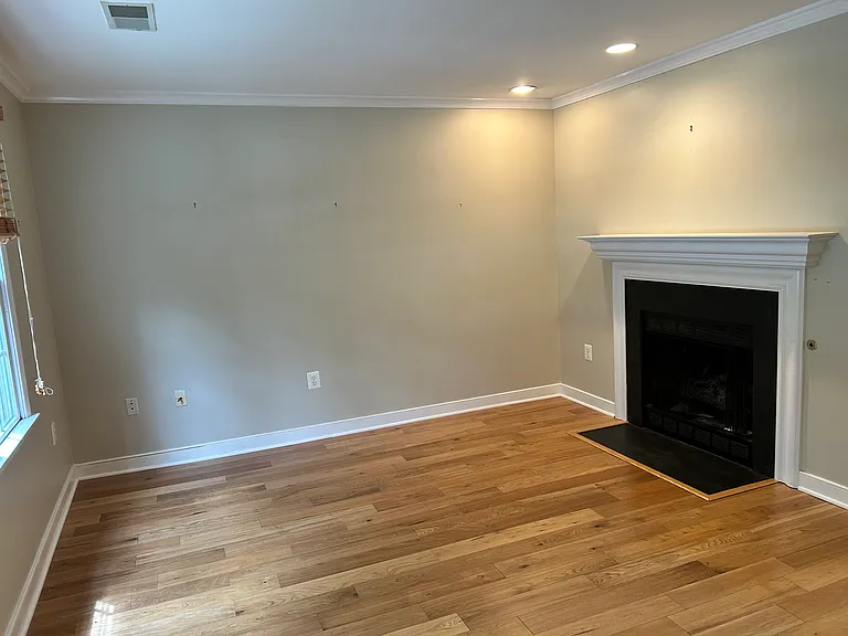 Living room boasts gas fireplace and new (3 year) wood floors