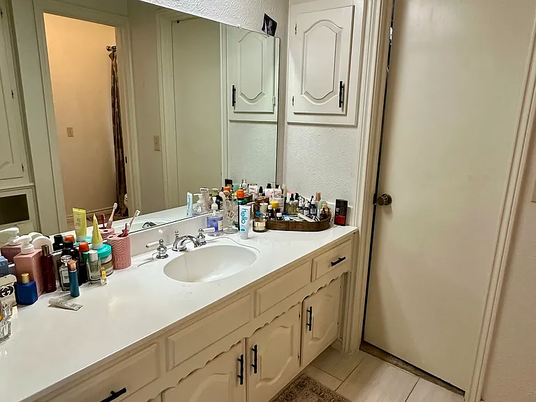 His and Hers primary bathroom with vanity and tile floors