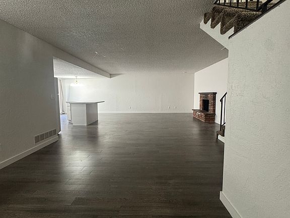 Living Area - Kitchen to the left, fireplace to the right.