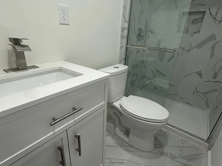 Full Bathroom with standing shower with glass door.