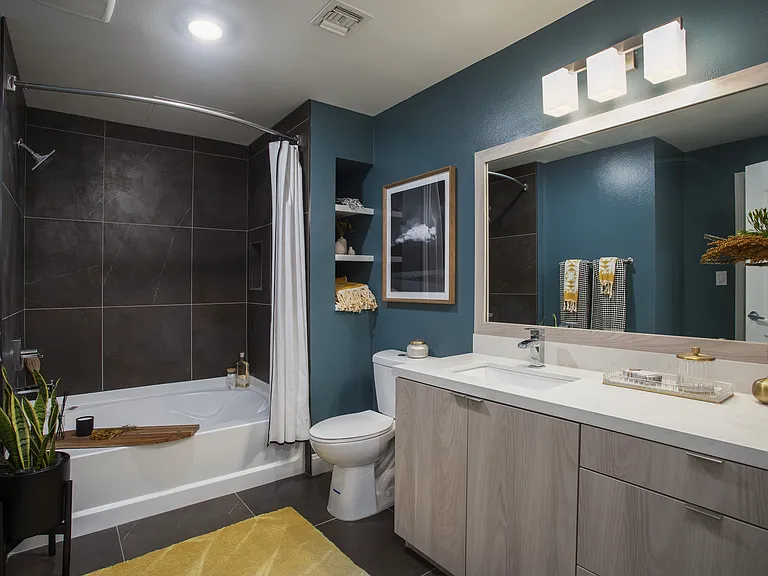 Bathroom with tiled tub enclosure at Reveal Playa Vista in Playa Vista, CA.