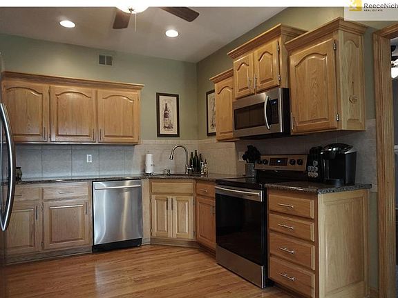 Kitchen with Granite Counter Tops and New Stainless Steel Appliances.