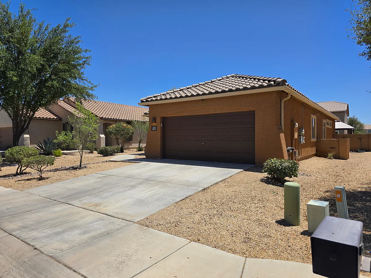 Driveway and sidewalk with view of side yard - 11297 W Massey Dr