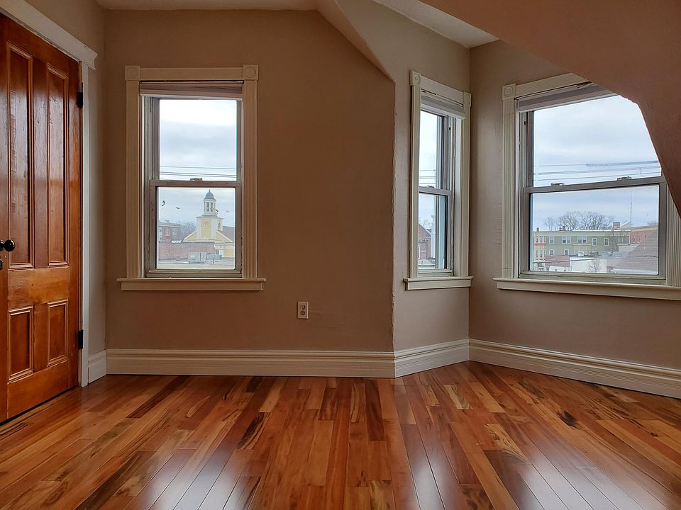 Freshly painted sunny large bedroom, hardwood flooring