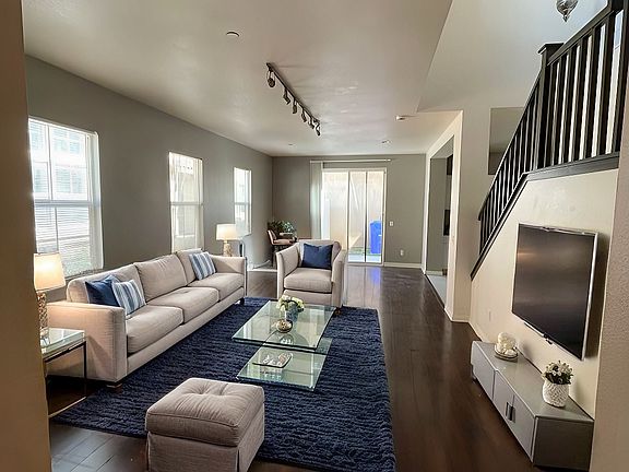 Spacious open floor plan living room + dining room. This image is virtually staged
