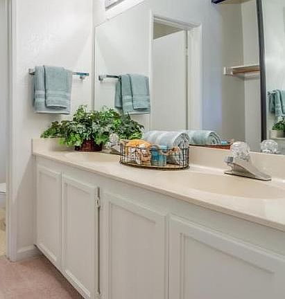 His and her sinks off of the master bedroom