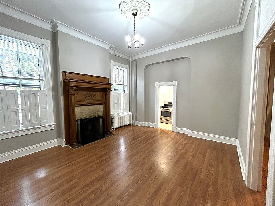 Beautiful high ceilings, wooden fireplace, and moldings.