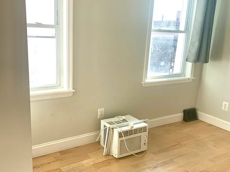 Sunny, oak floored bedroom.