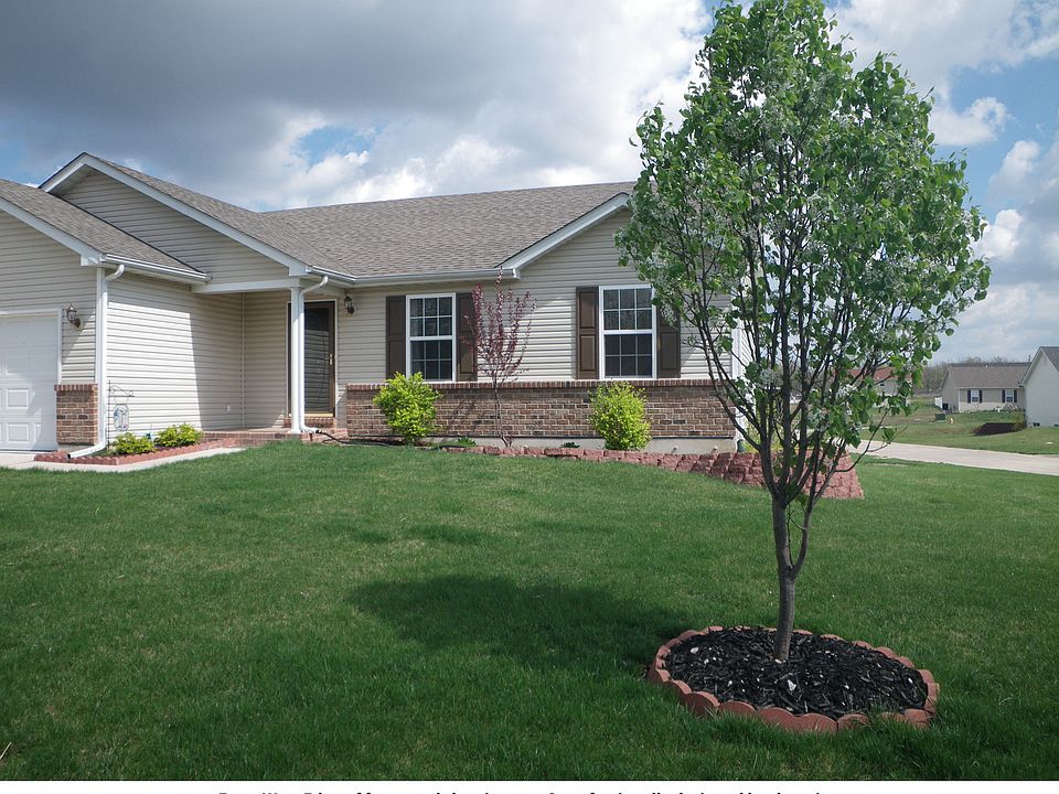 From west edge of yard showing tree & professionally designed landscaping.