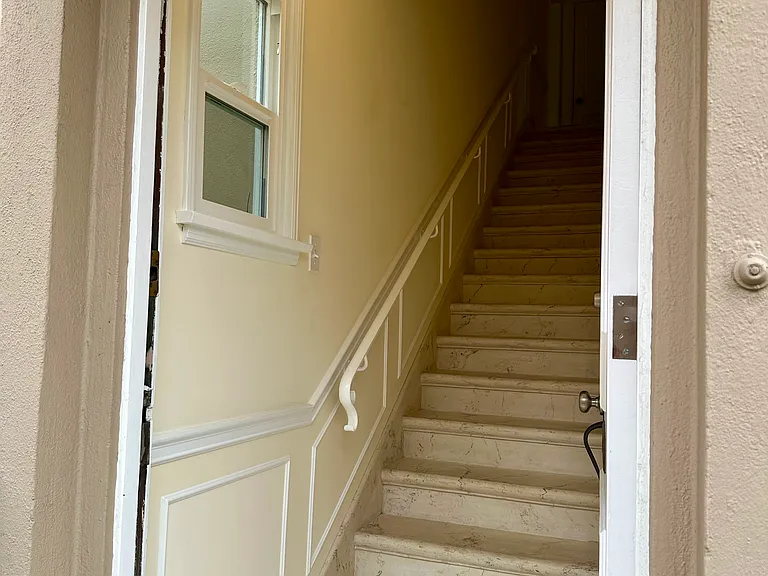 Private staircase, beautiful flooring, nice lighting, and the window lets the sunlight in