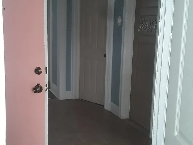 Inside bedroom 2, backdoor pink door, bathroom brown door