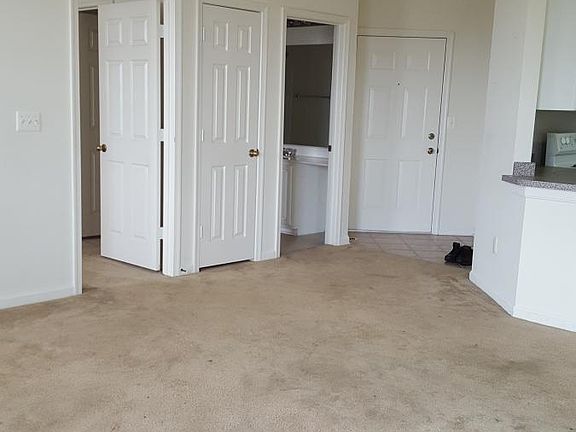 Looking from patio door to front door, second bedroom and bathroom