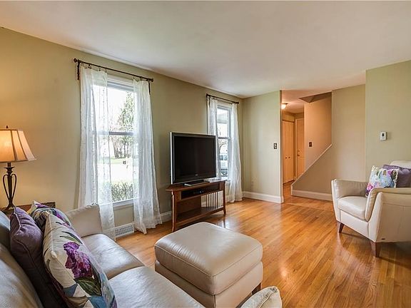 Well Lit Spacious Living Room with Stunning Hardwood Flooring