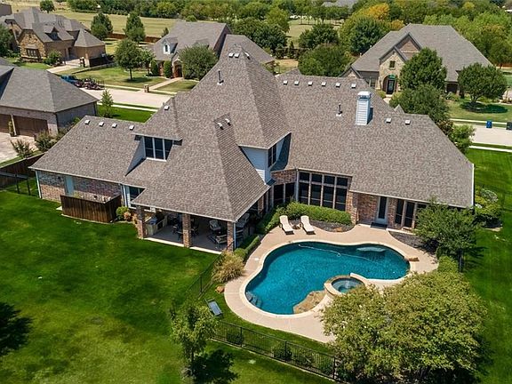 Aerial rear view of this magnificent property. Brand new salt cell in the pool. Brand new cedar fencing. Solar screens. Large covered patio with built in grill.