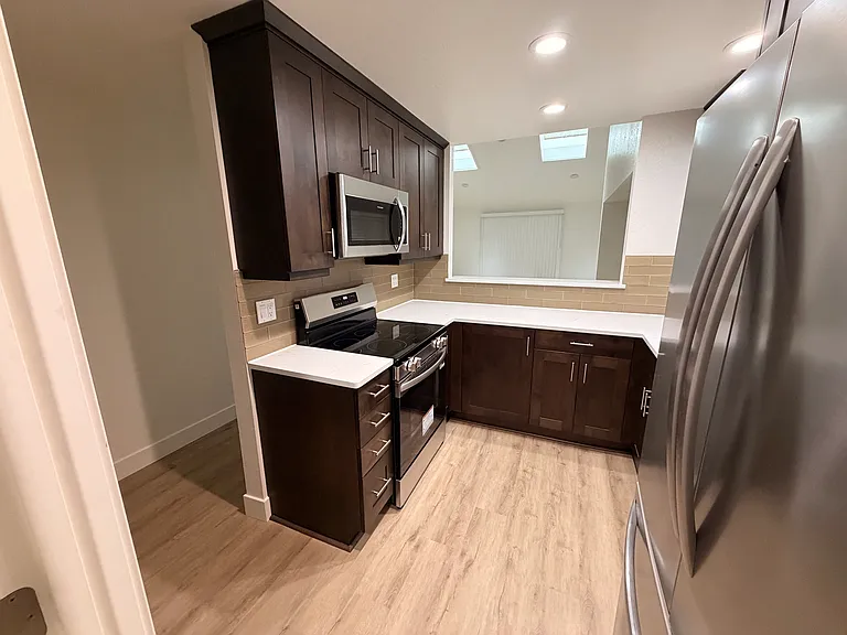 Kitchen with quartz countertops and brand new stainless steel appliances