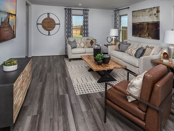 The comfortable family room is the go-to gathering spot in the home with welcoming windows that fill