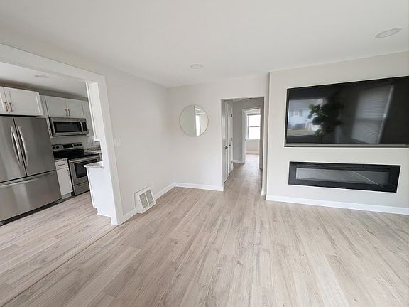 Left: Kitchen
Center: Hallway to main floor bathroom
Right Living room