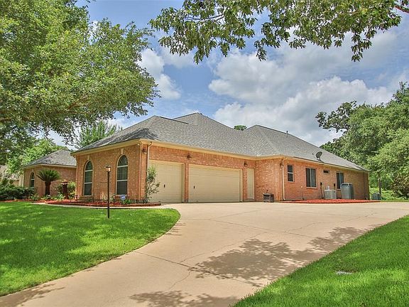 The side entry 3 car garage is equipped with 3 ceiling fans and lots of shelves for storage. Access from the garage into the house is through the utility room. There is additional parking and turn around space for two cars. The roof was replaced in 2