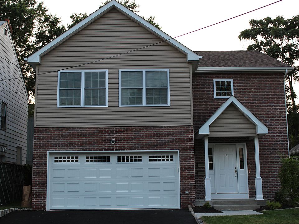 Modern newly built home with private driveway and brick facade.
