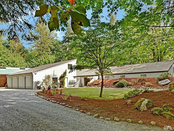 Custom, energy efficient, beautifully updated rambler with a large 3 car garage with studio above and huge detached shop/garage.