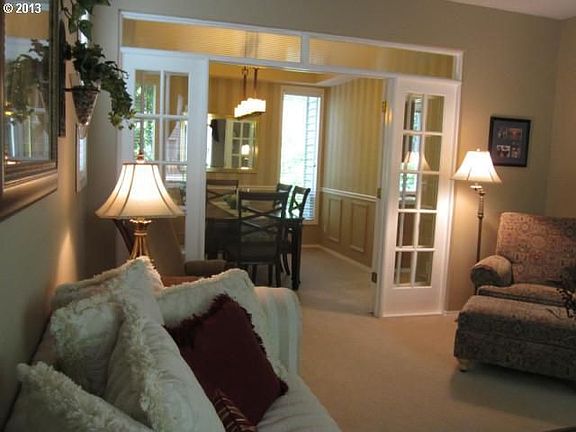 Formal living room opens into the formal dining room by way of lovely french doors.