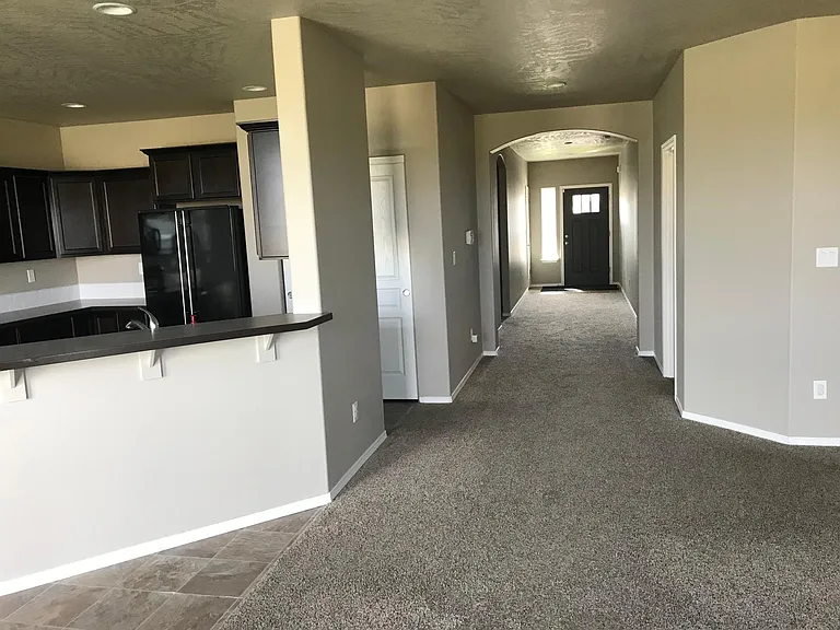 Long hallway view from living room to front door