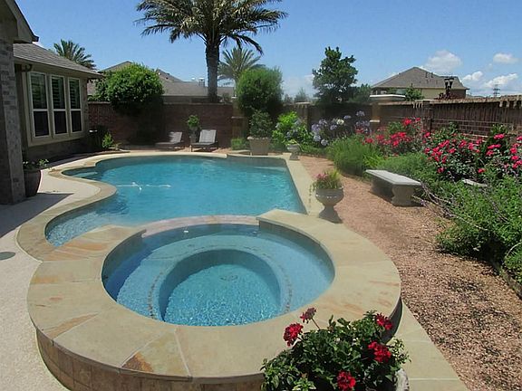BACK YARD IN GROUND SALT WATER POOL AND LUSH LANDSCAPING